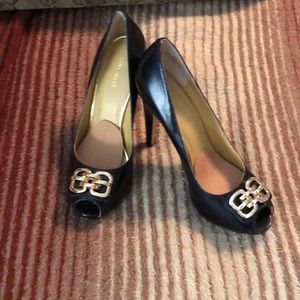 Black heels with a gold accent.